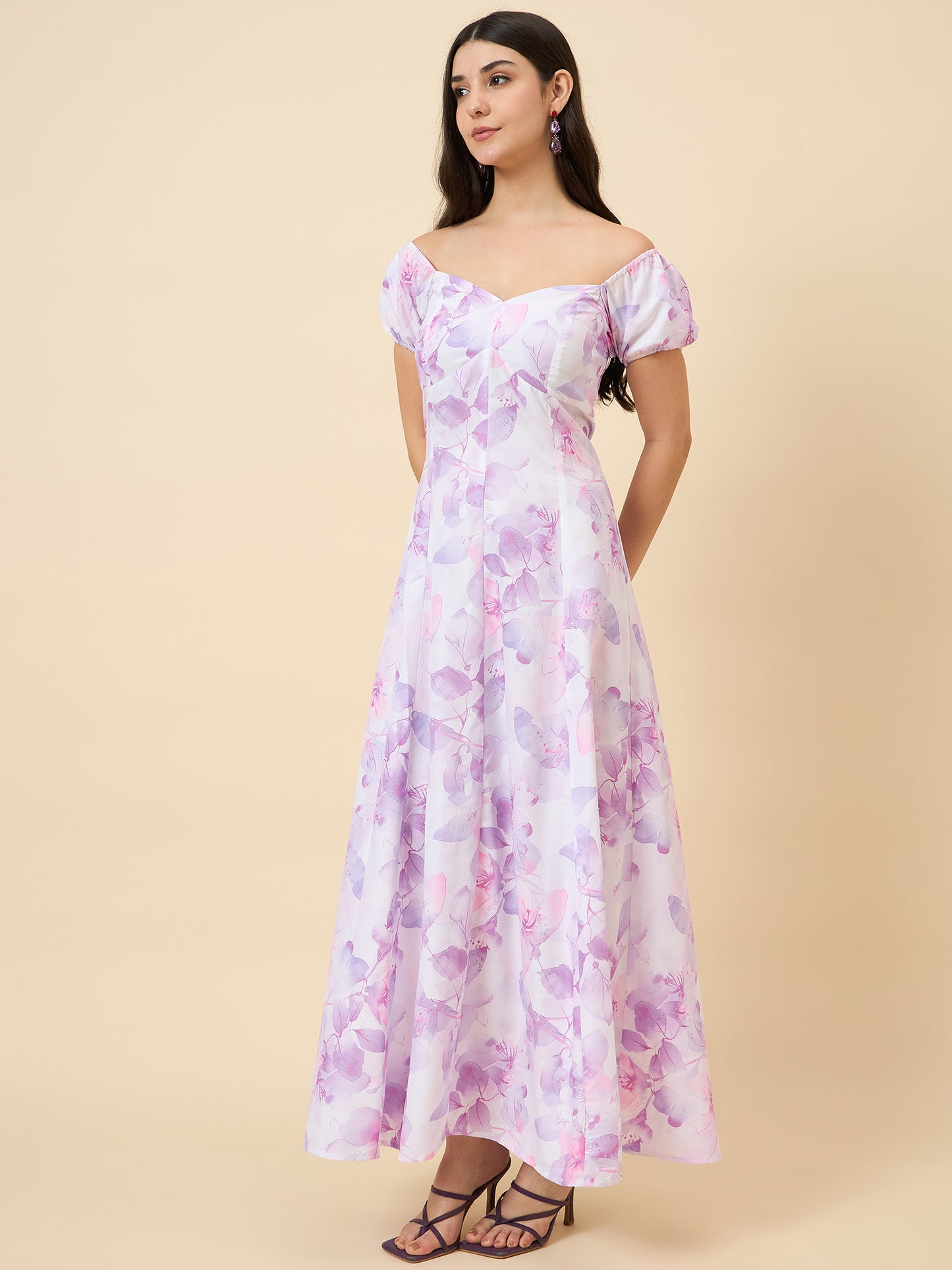 Woman wearing a floral dress on a beige background