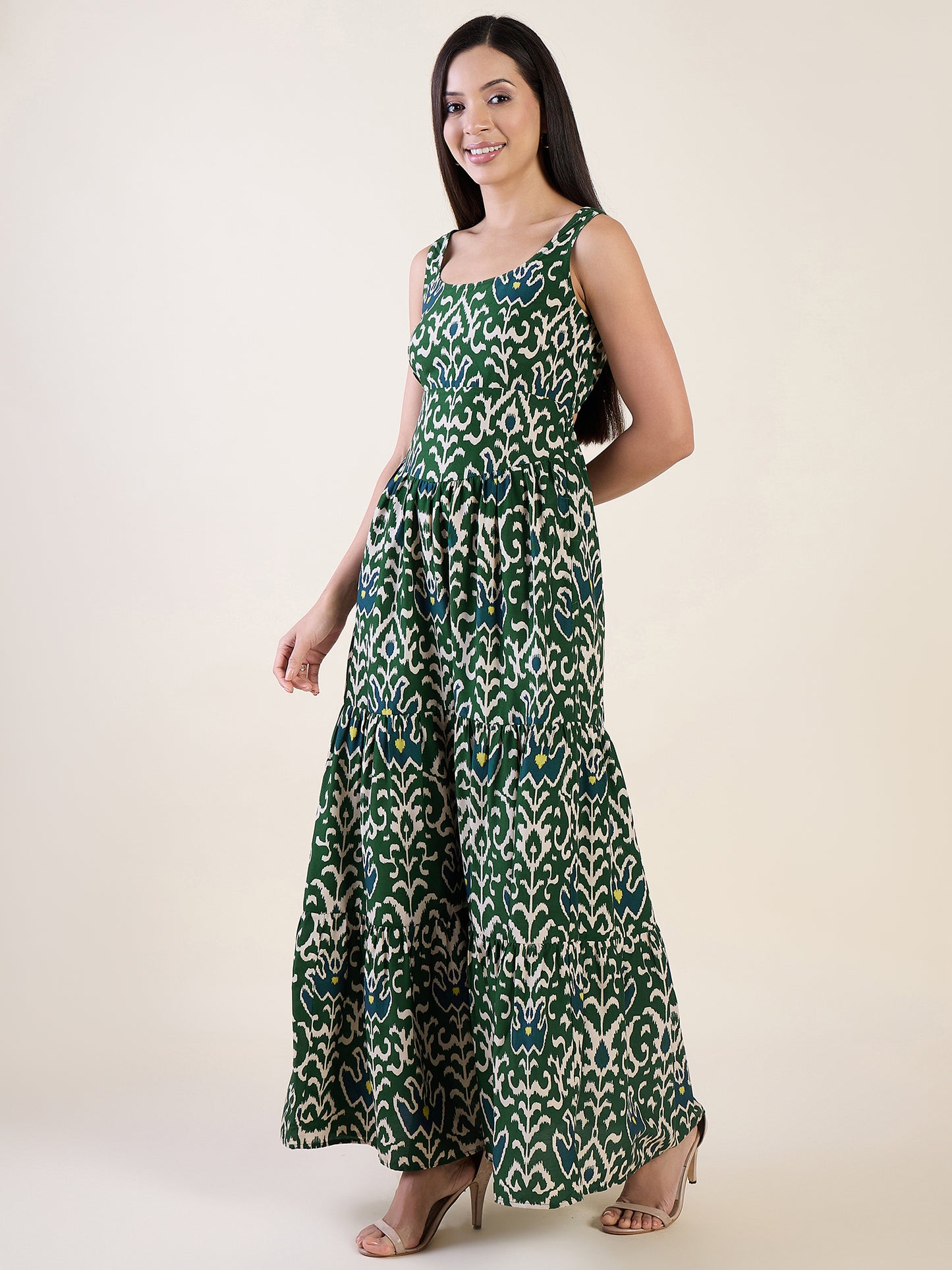 Woman wearing a green patterned dress on a white background