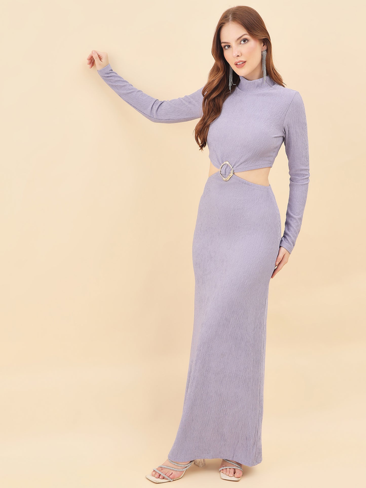 Woman wearing a long purple dress with cutout design on a beige background