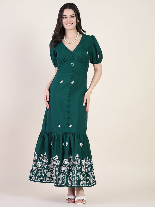 Emerald green embroidered maxi dress on beige background