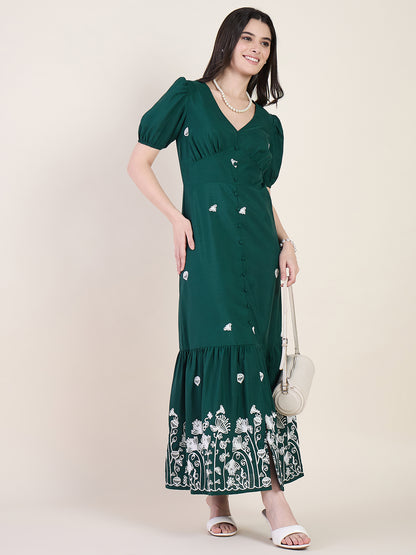 Emerald green embroidered maxi dress on beige background