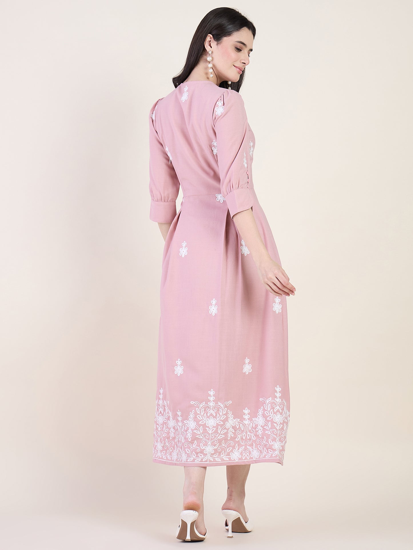 Blush pink embroidered midi dress on beige background