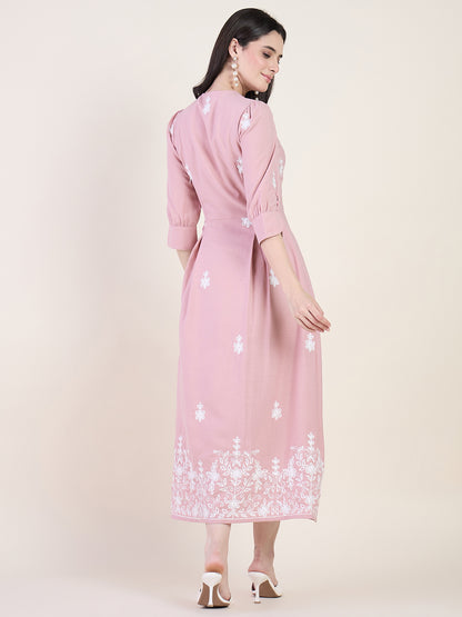 Blush pink embroidered midi dress on beige background