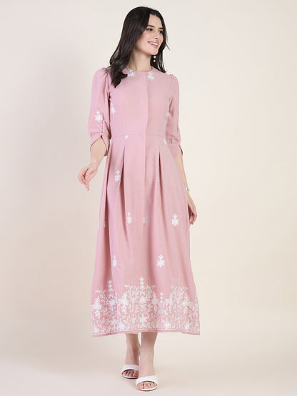 Blush pink embroidered midi dress on beige background