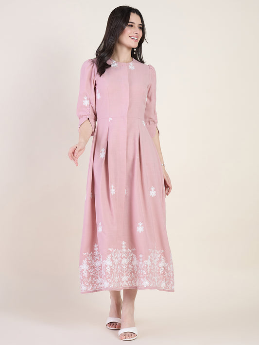 Blush pink embroidered midi dress on beige background
