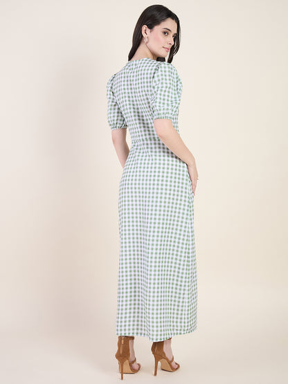 Woman wearing a green checkered dress on a beige background