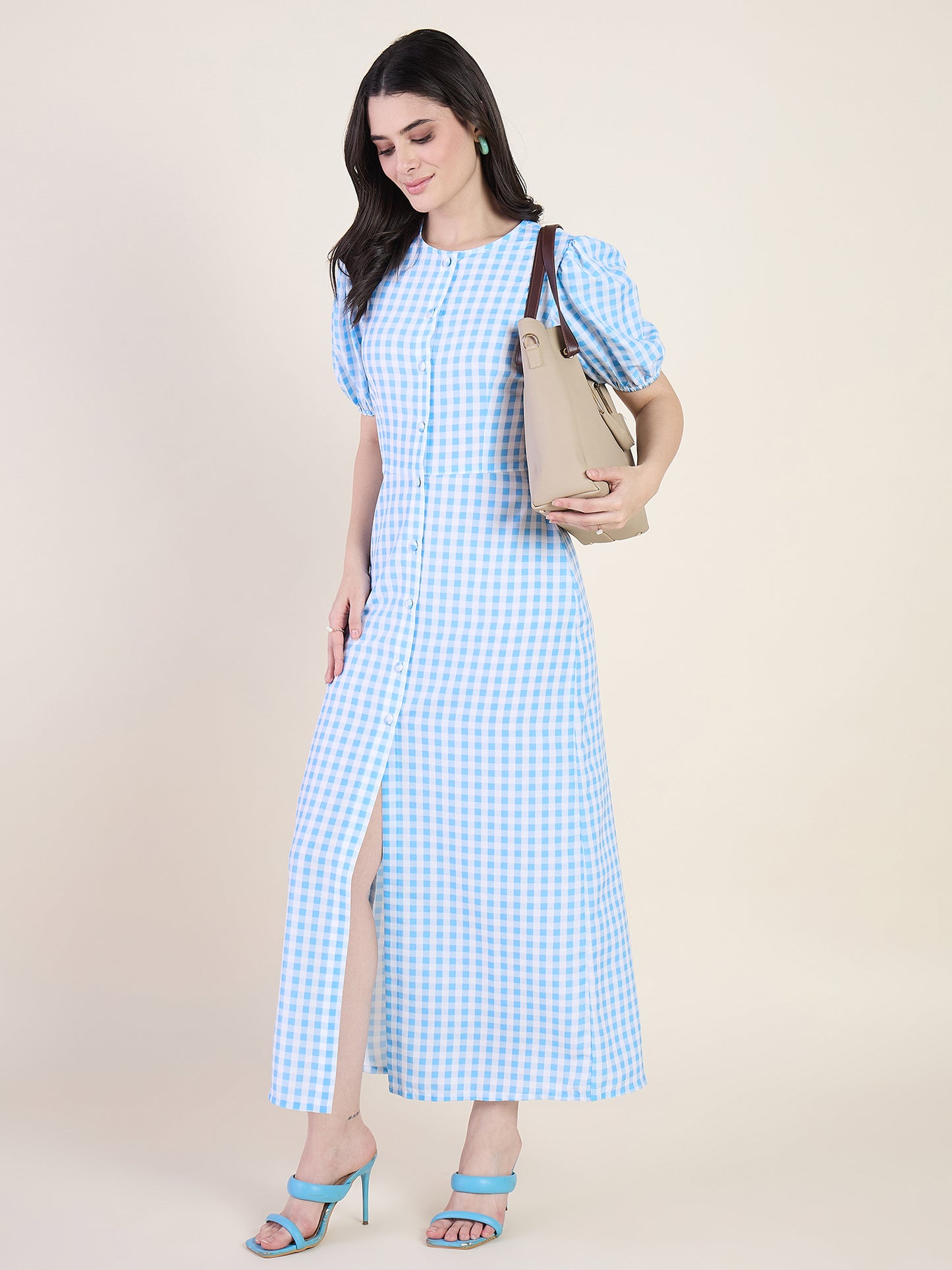Woman wearing a blue checkered dress on a beige background