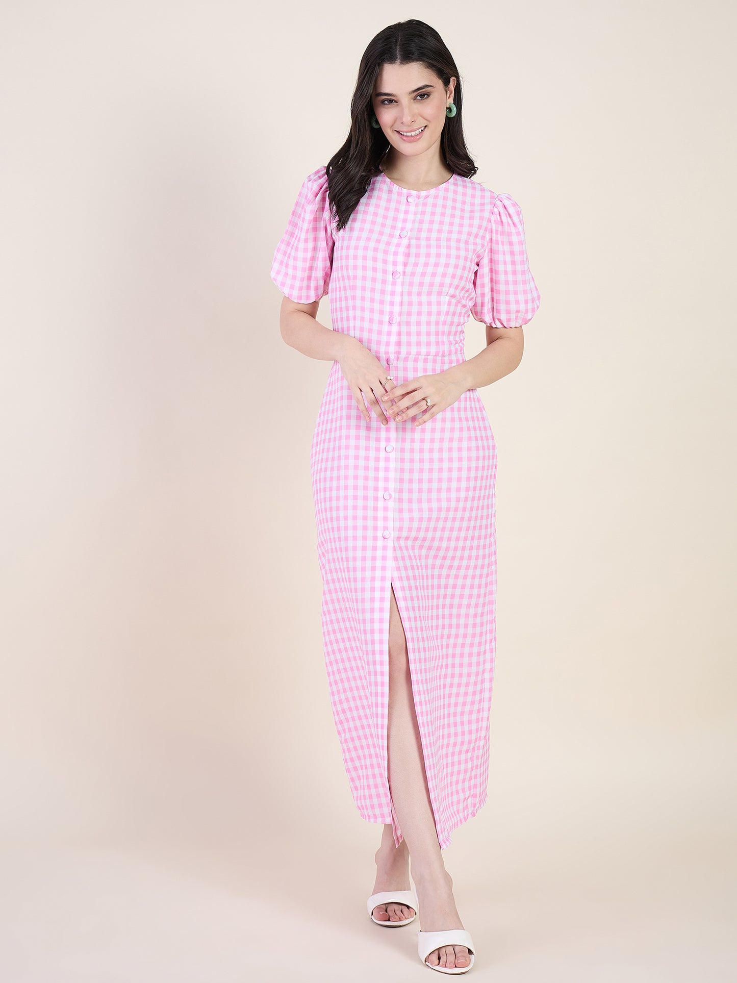 Woman wearing a pink checkered dress on a beige background