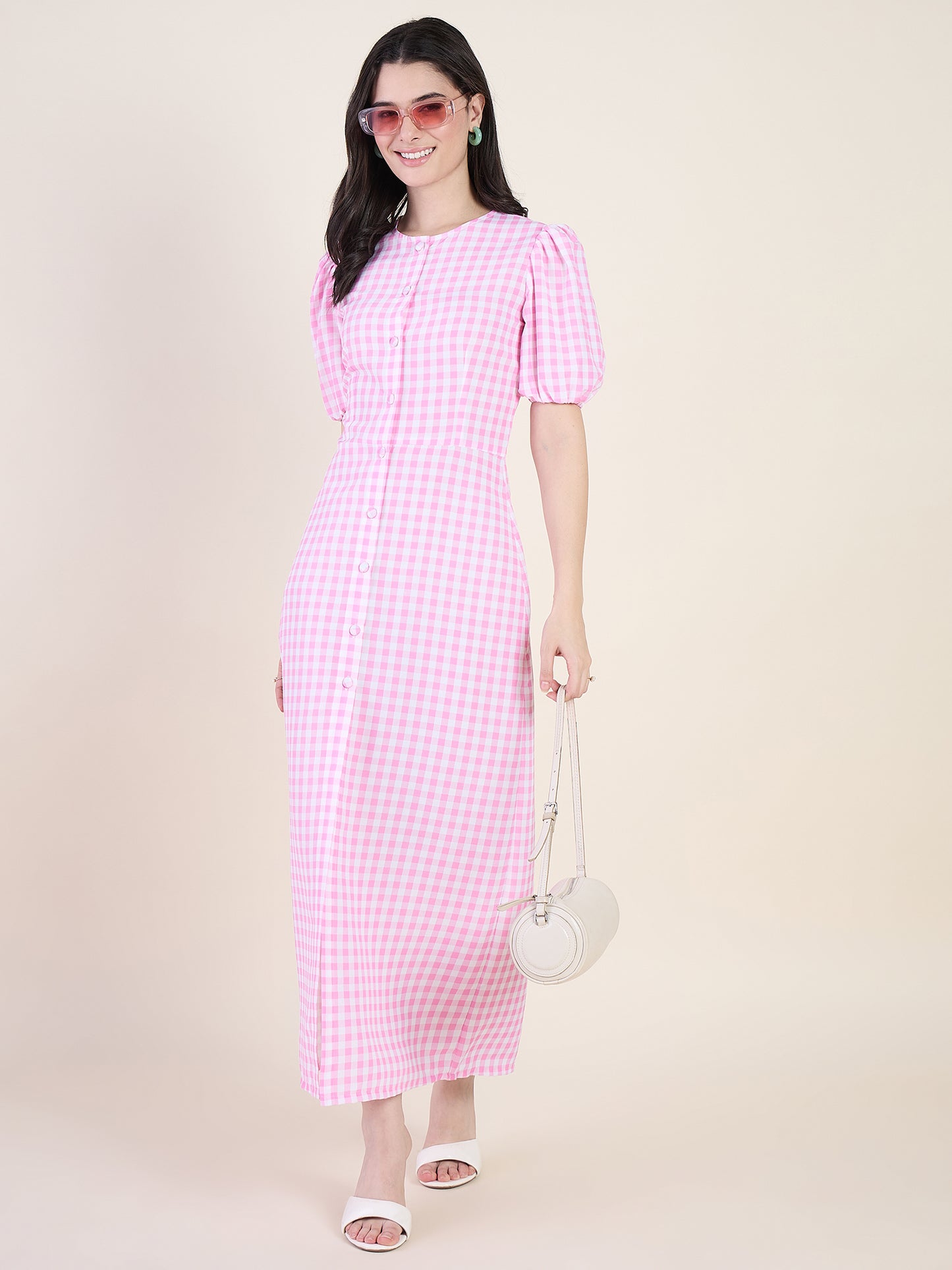 Woman wearing a pink checkered dress on a beige background