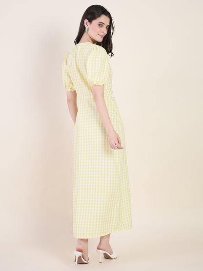 Woman wearing a yellow checkered dress on a beige background