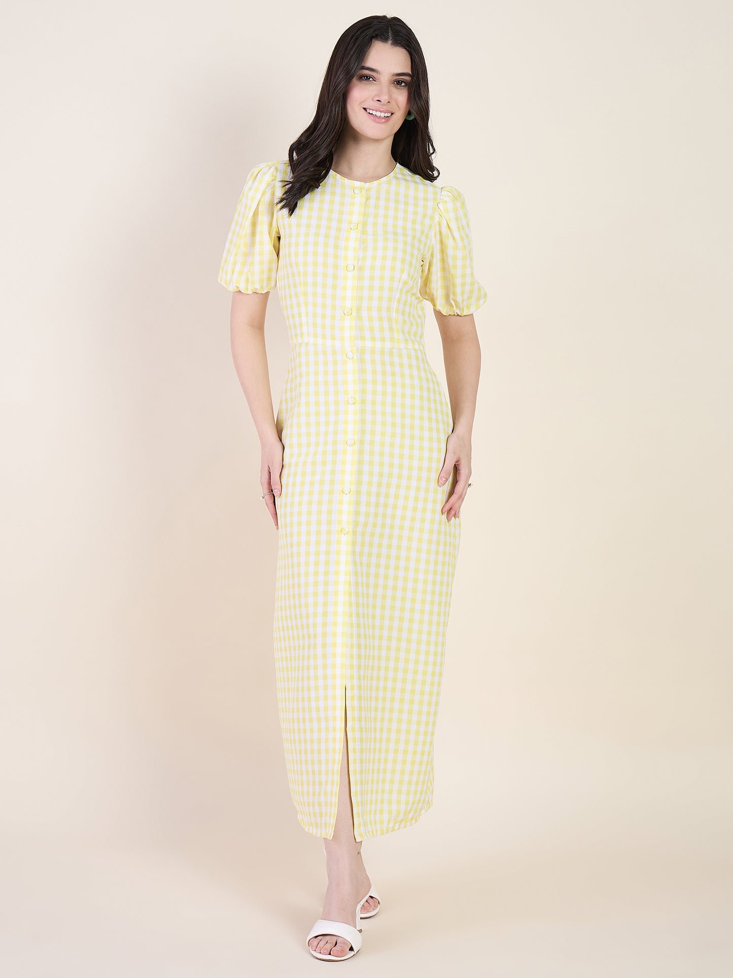 Woman wearing a yellow checkered dress on a beige background