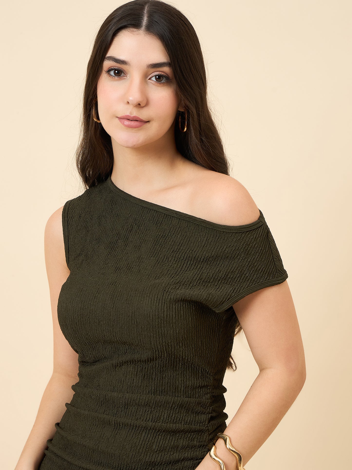 one-shoulder bodycon green midi on pink background