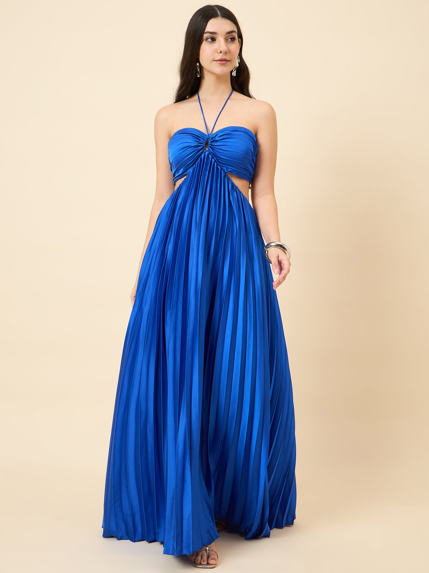 Woman wearing a blue strapless gown on a beige background