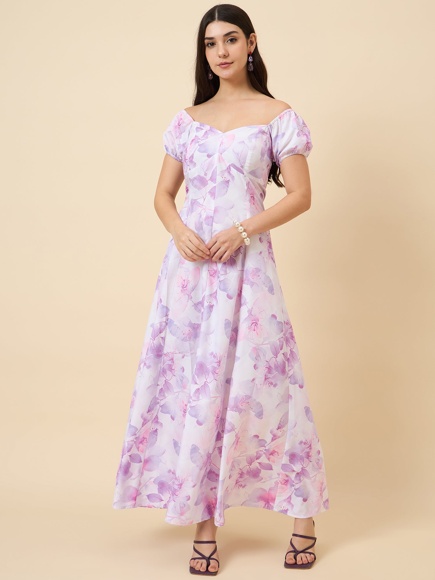 Woman wearing a floral off-shoulder dress on a beige background