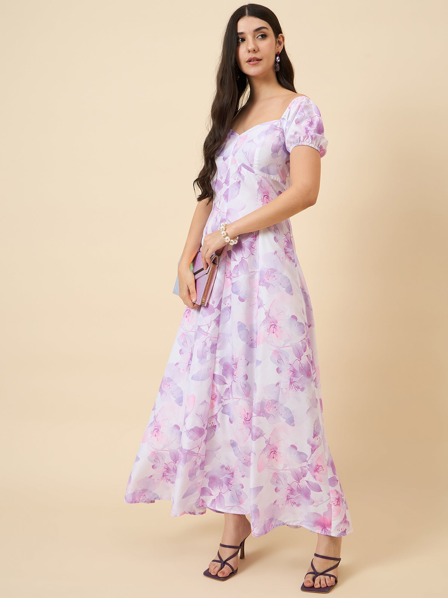 Woman wearing a floral dress on a beige background