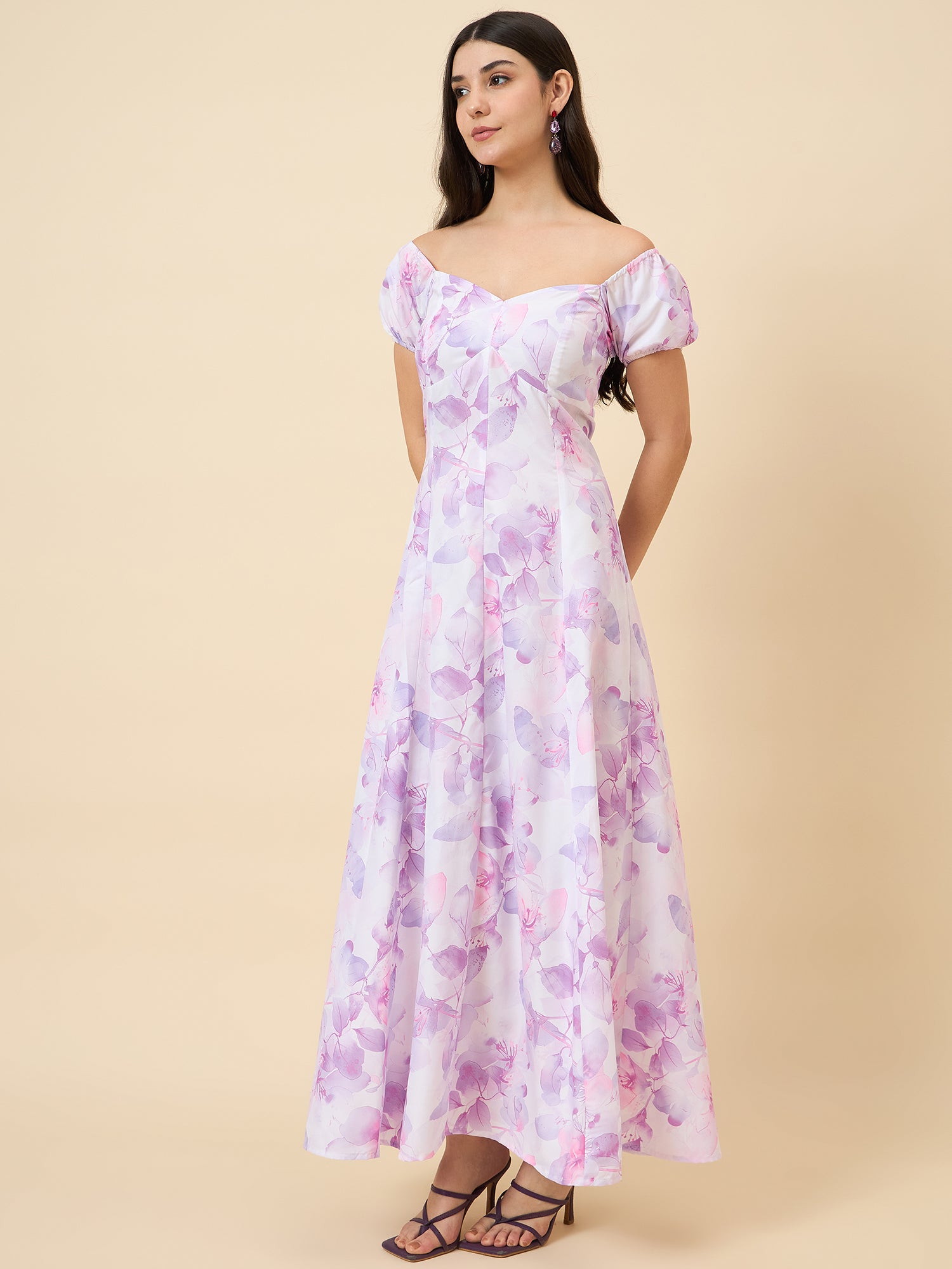 Woman wearing a floral dress on a beige background