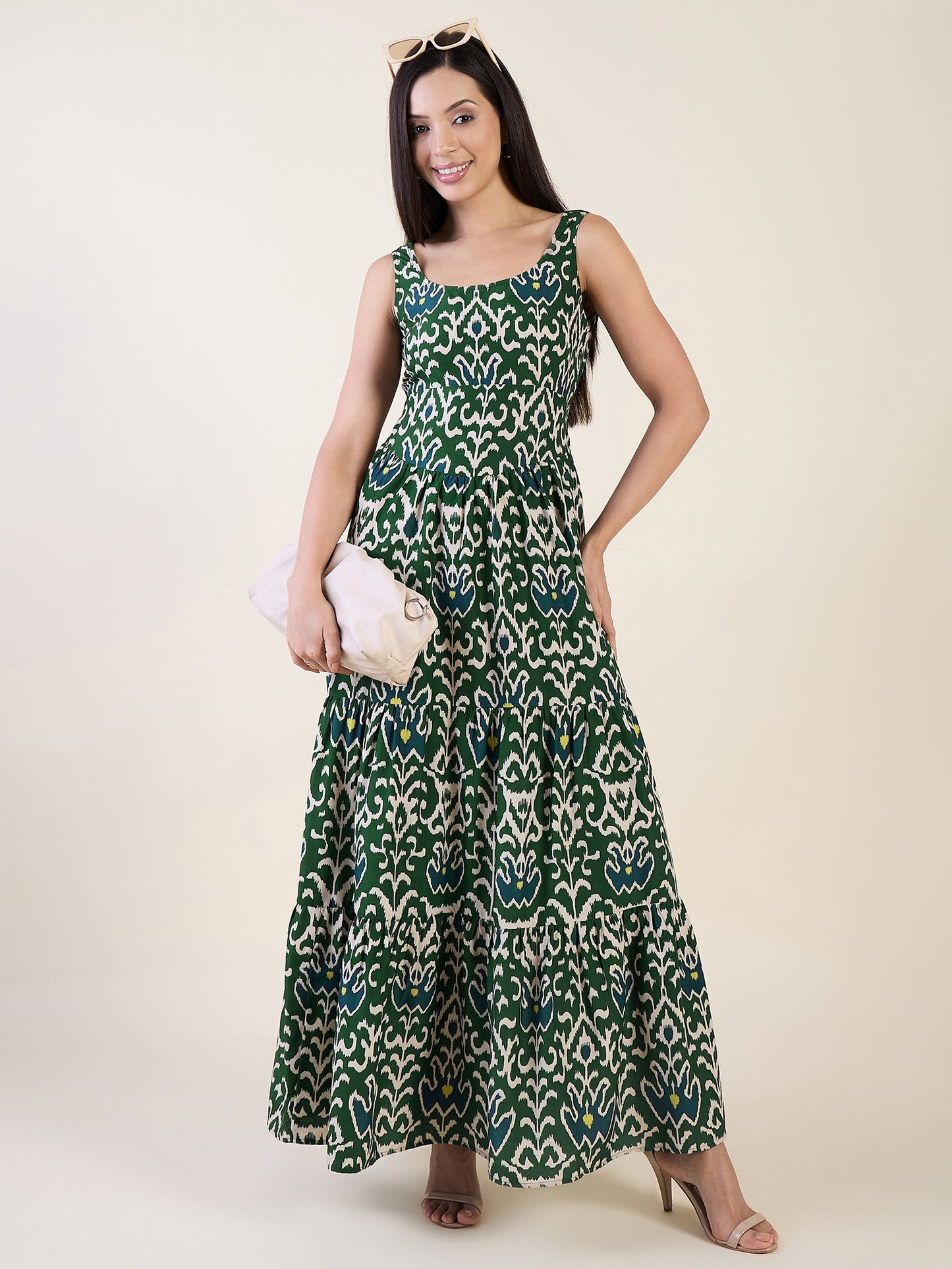 Woman wearing a green patterned dress on a white background