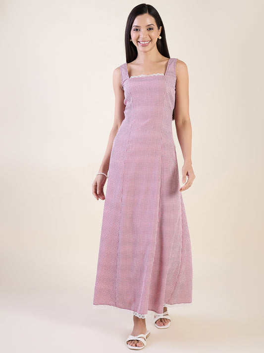 Woman wearing a pink and white striped dress on a plain background