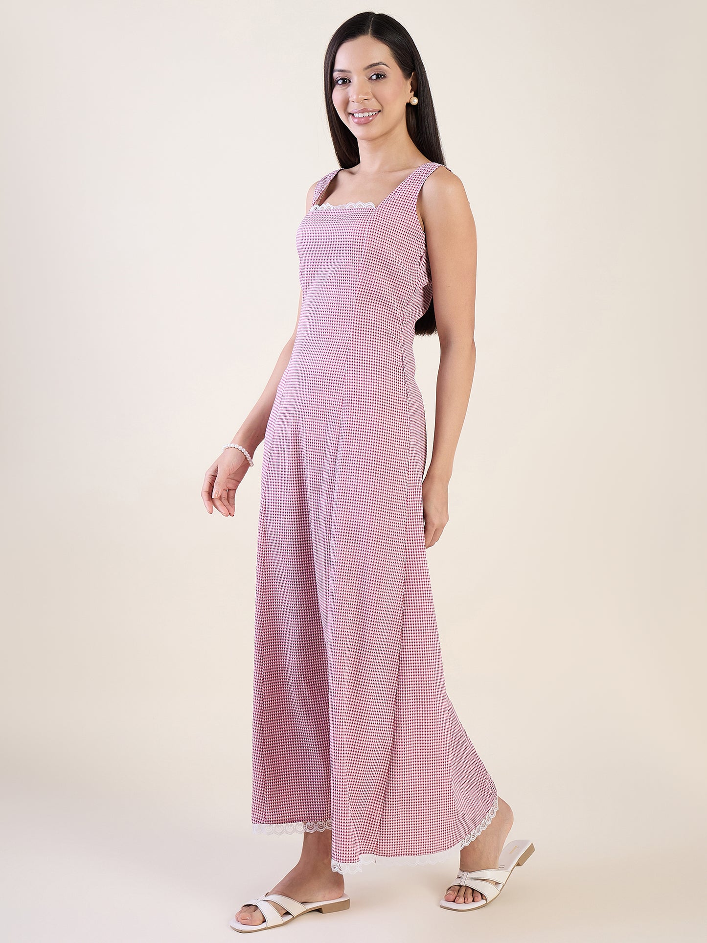 Woman wearing a pink sleeveless dress on a white background