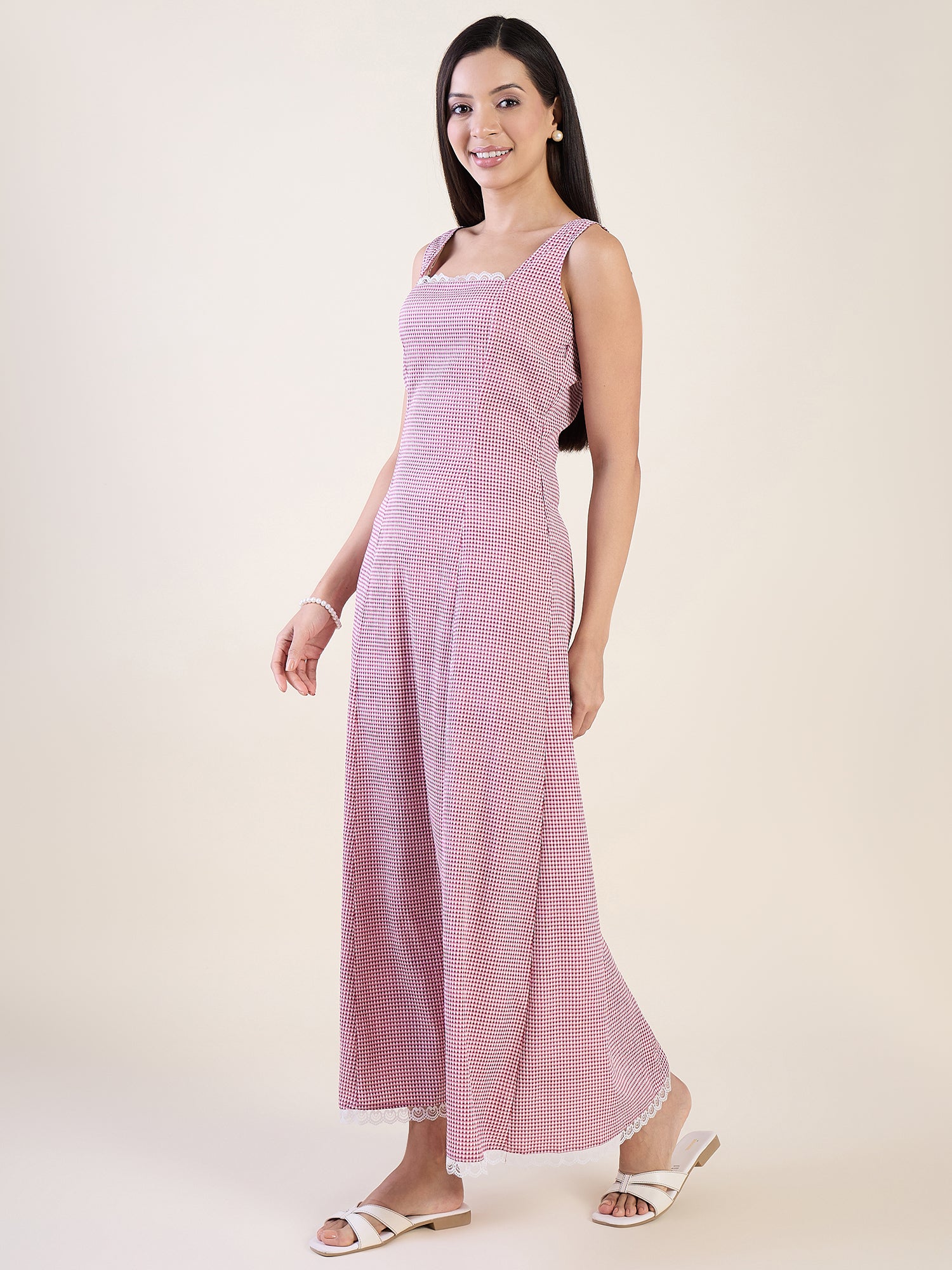 Woman wearing a pink sleeveless dress on a white background