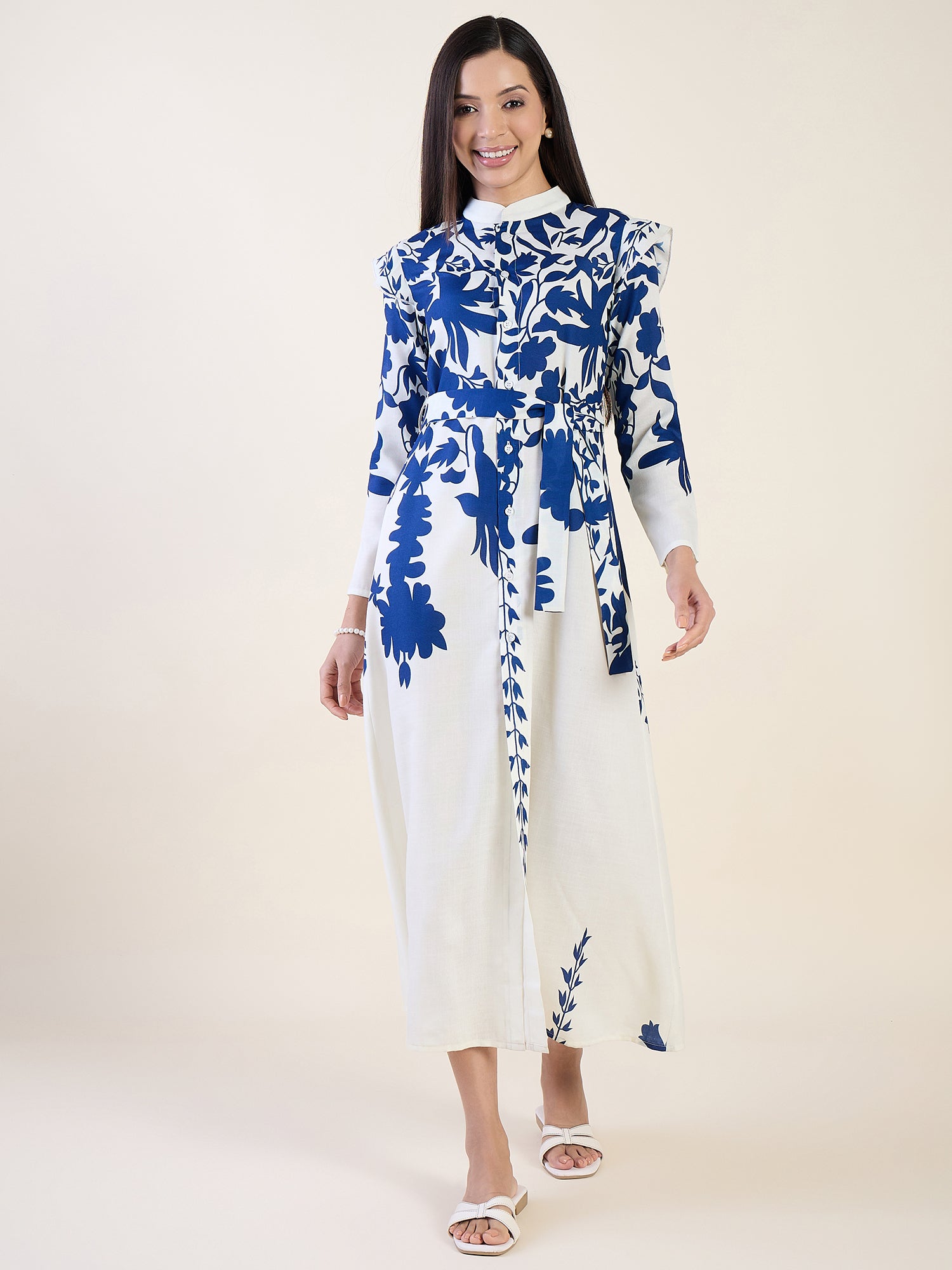 Woman wearing a blue and white floral dress on a white background