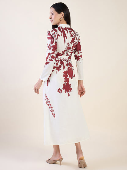 Woman wearing a white dress with red floral patterns on a plain background