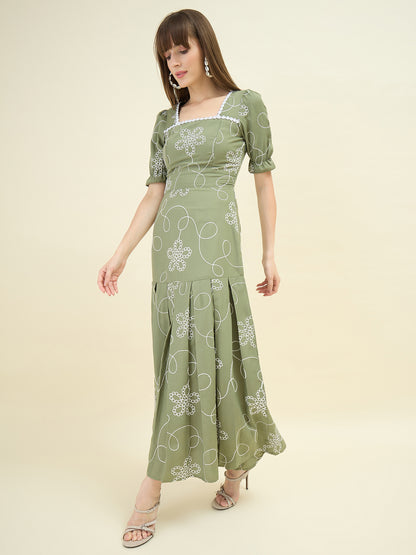Woman wearing a green floral dress on a beige background