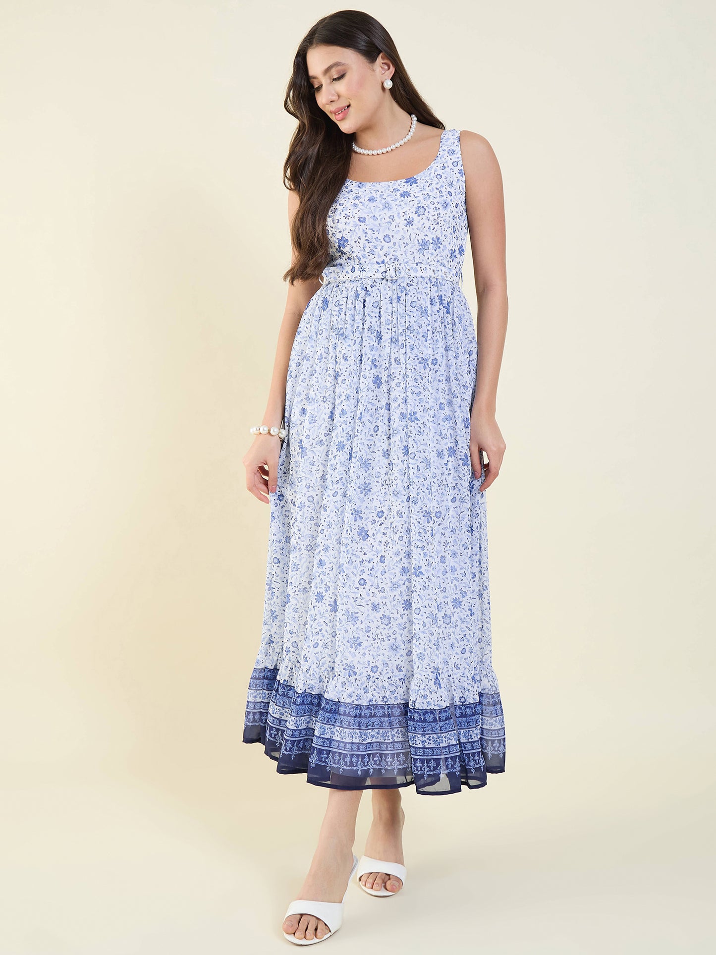 Woman wearing a blue floral dress on a beige background