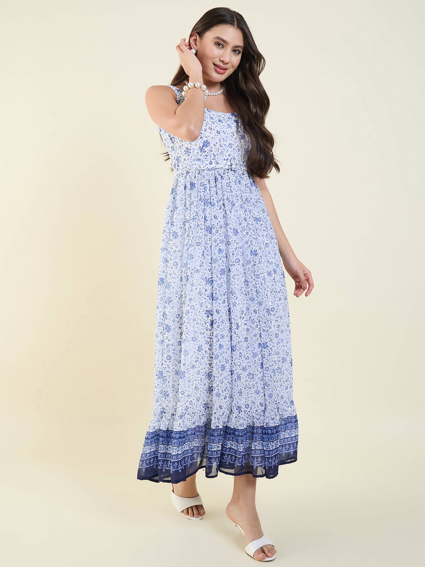 Woman wearing a blue floral dress on a beige background