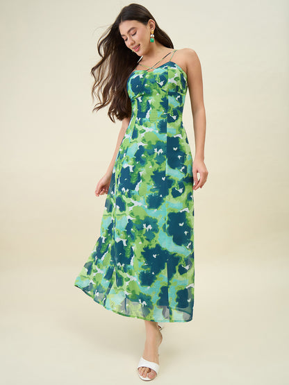 Woman wearing a green floral dress against a beige background