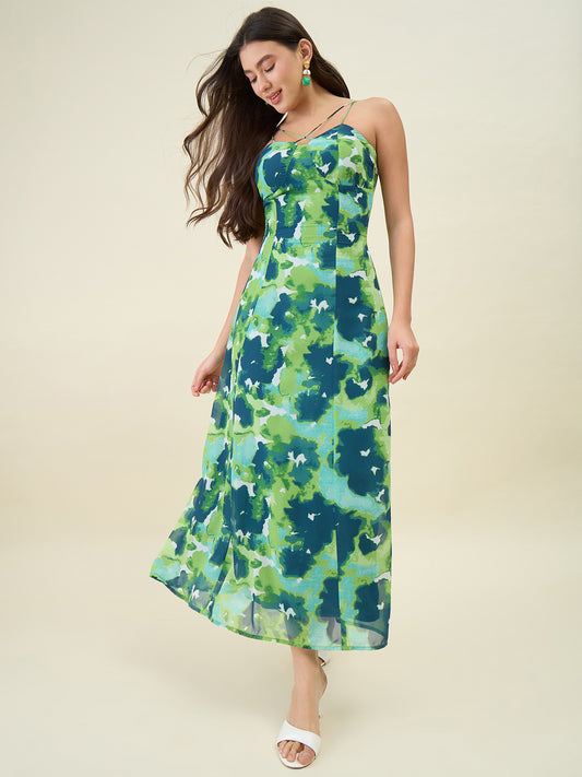 Woman wearing a green floral dress against a beige background
