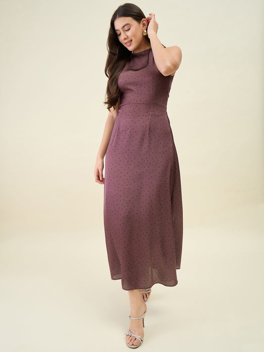 Woman wearing a brown dress against a plain background