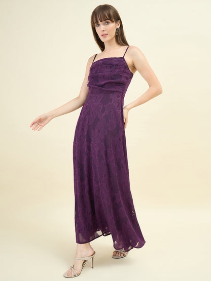 Woman wearing a purple lace dress on a beige background