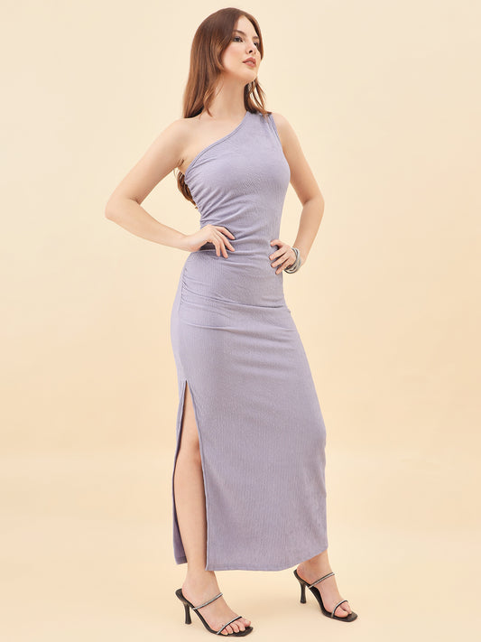 Woman wearing a one-shoulder purple dress on a beige background