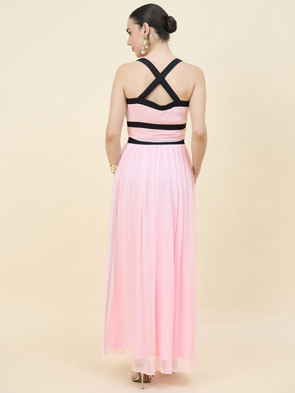 Woman wearing a pink and black dress with a gradient effect on a beige background