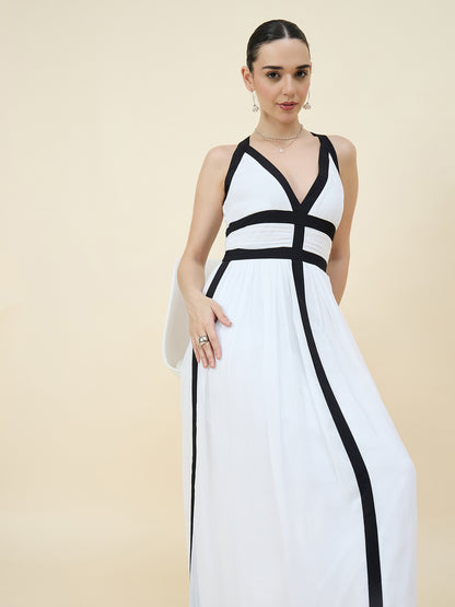 Woman wearing a white dress with black accents on a beige background