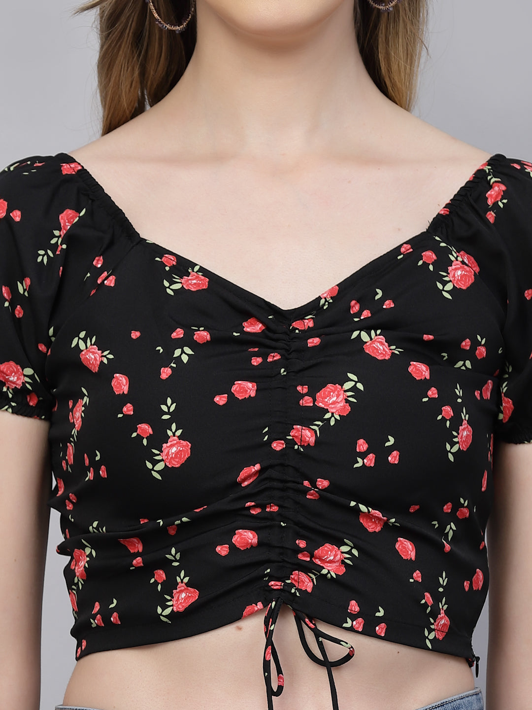 Black & pink top with red floral pattern on a plain background