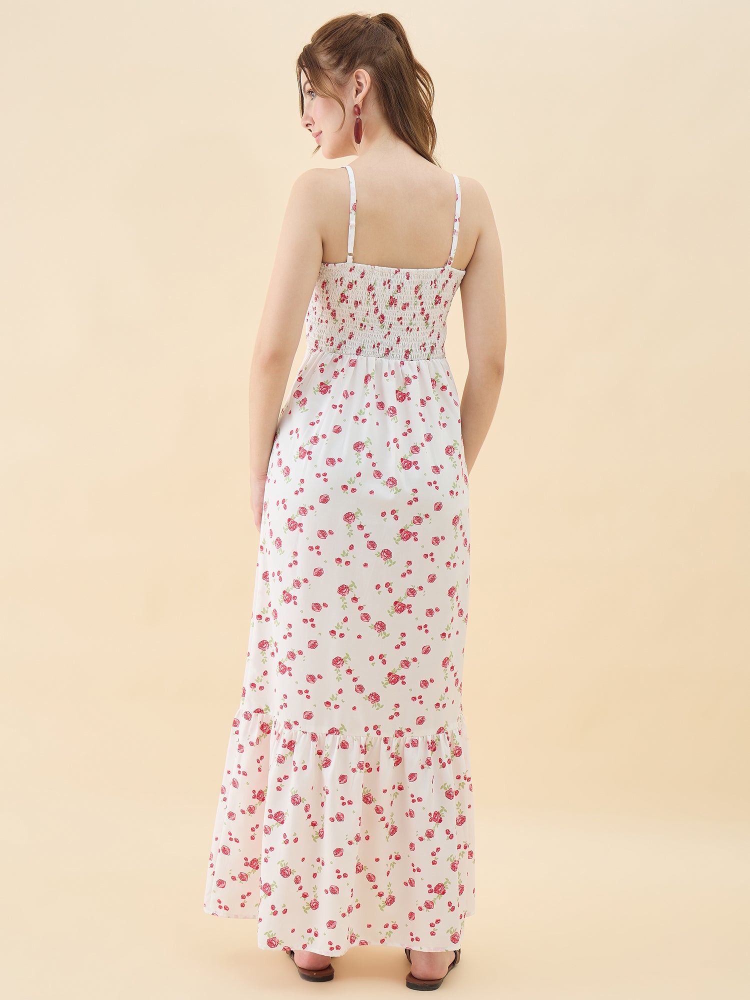 Woman wearing a floral dress on a beige background