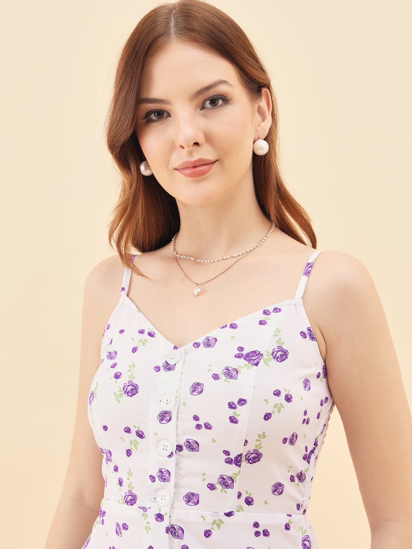 Woman wearing a floral dress with a plain background