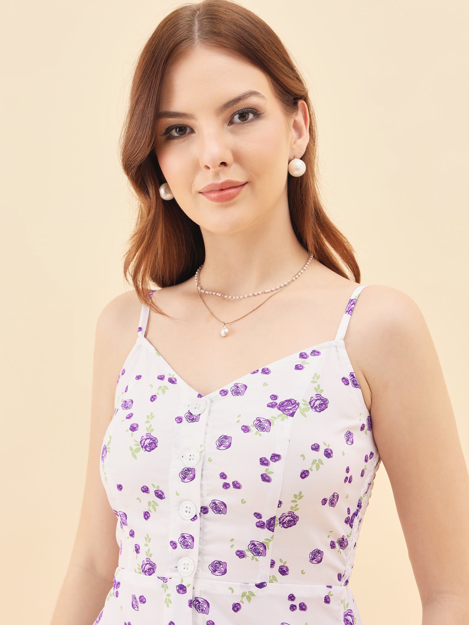 Woman wearing a floral dress with a plain background