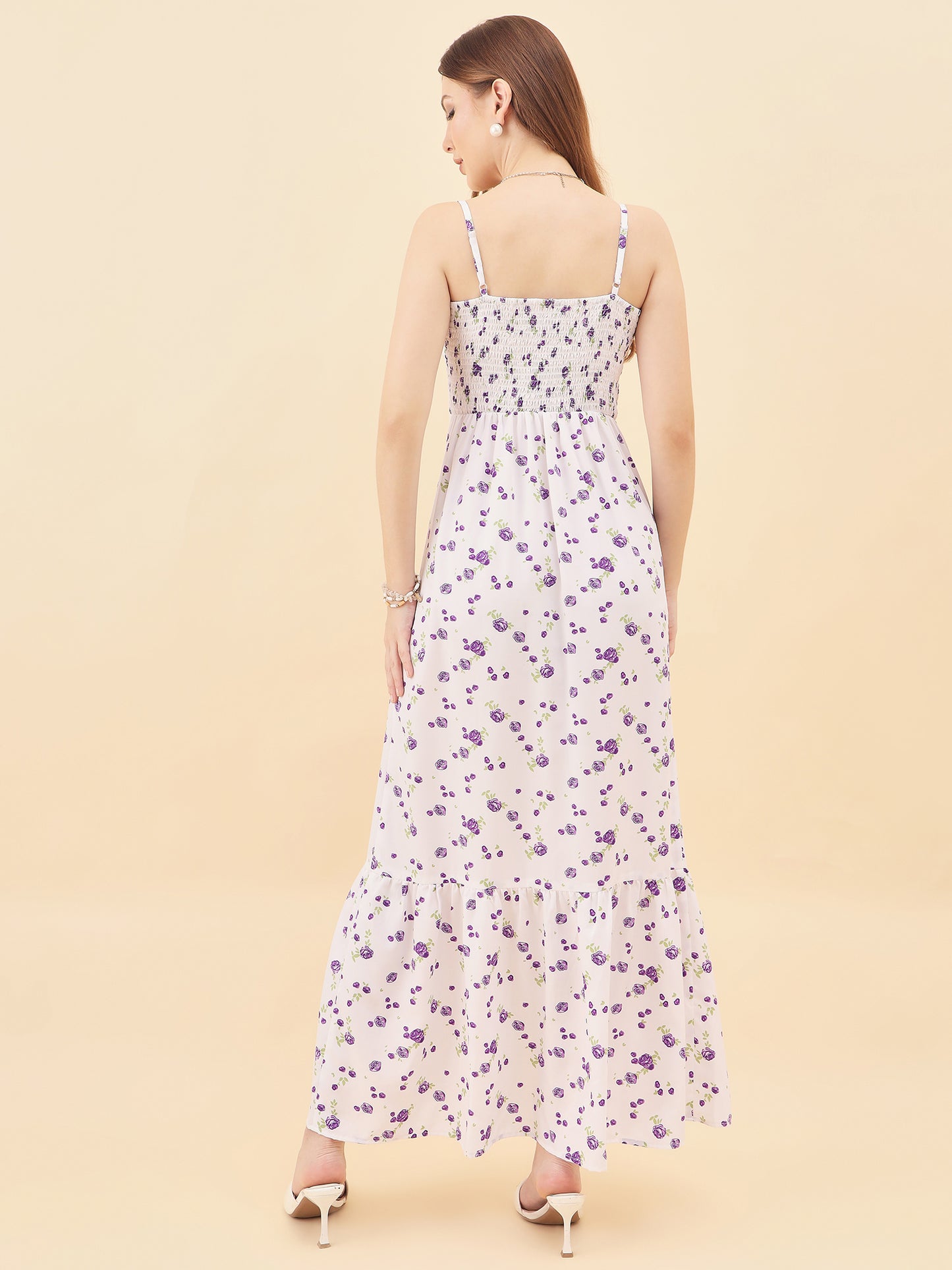 Woman wearing a floral dress on a beige background