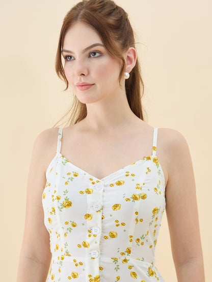 Woman wearing a white dress with yellow floral pattern against a beige background