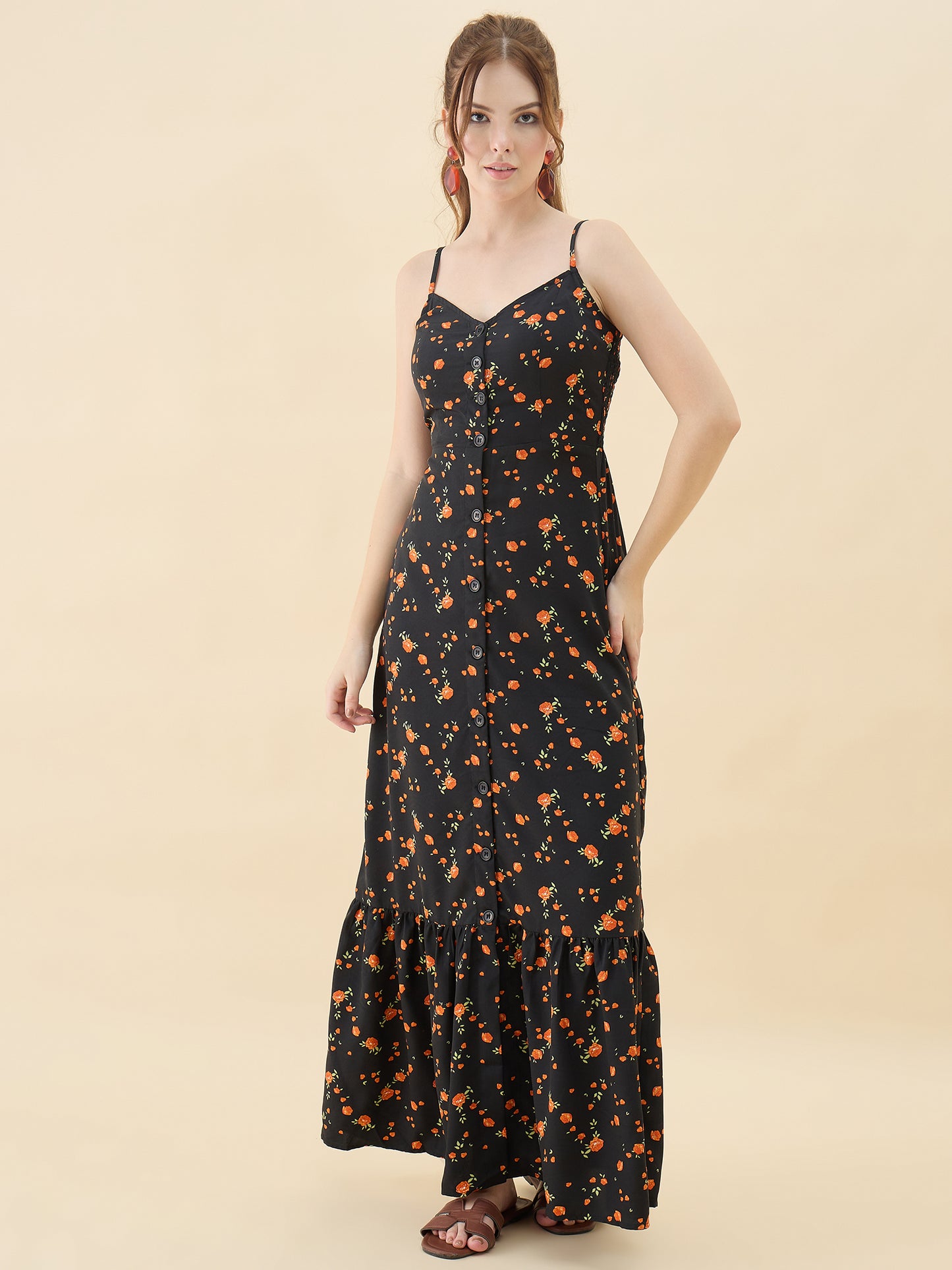 Woman wearing a black floral dress against a beige background