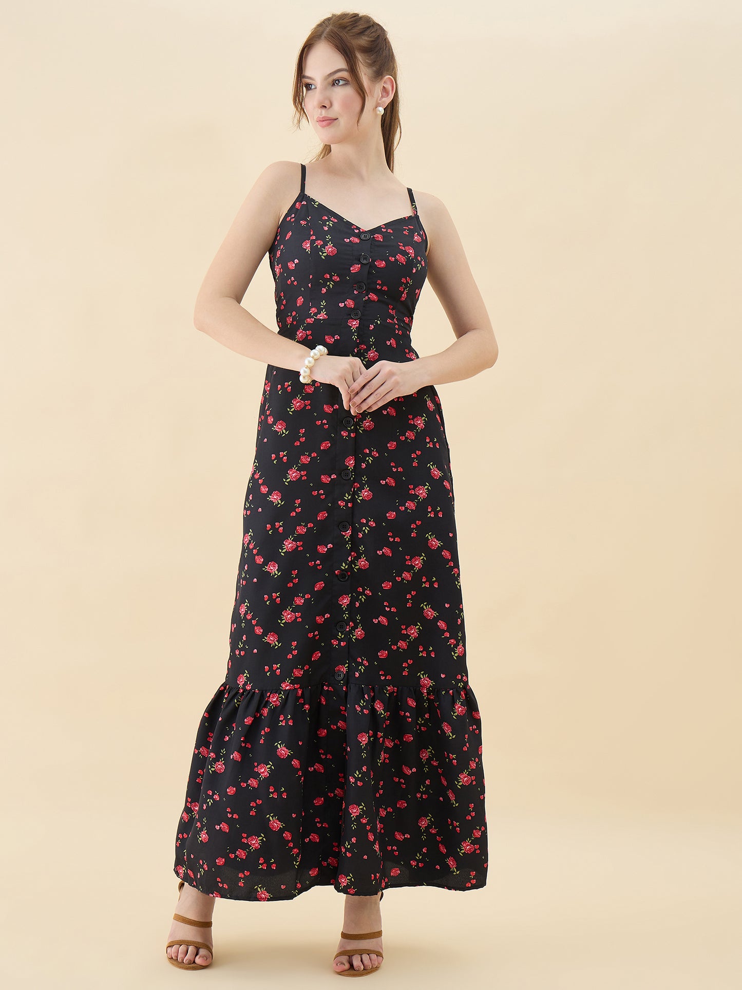 Woman wearing a black floral dress on a beige background