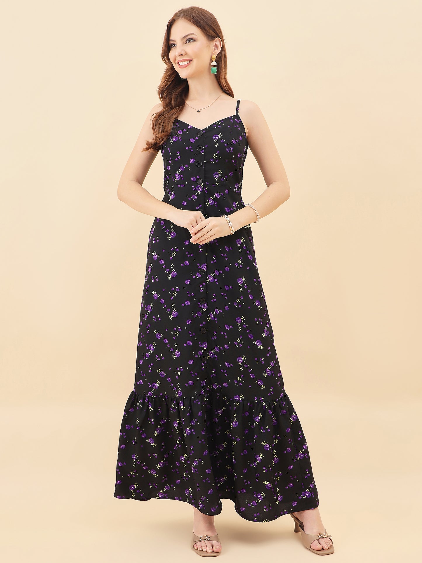 Woman wearing a black floral dress on a beige background