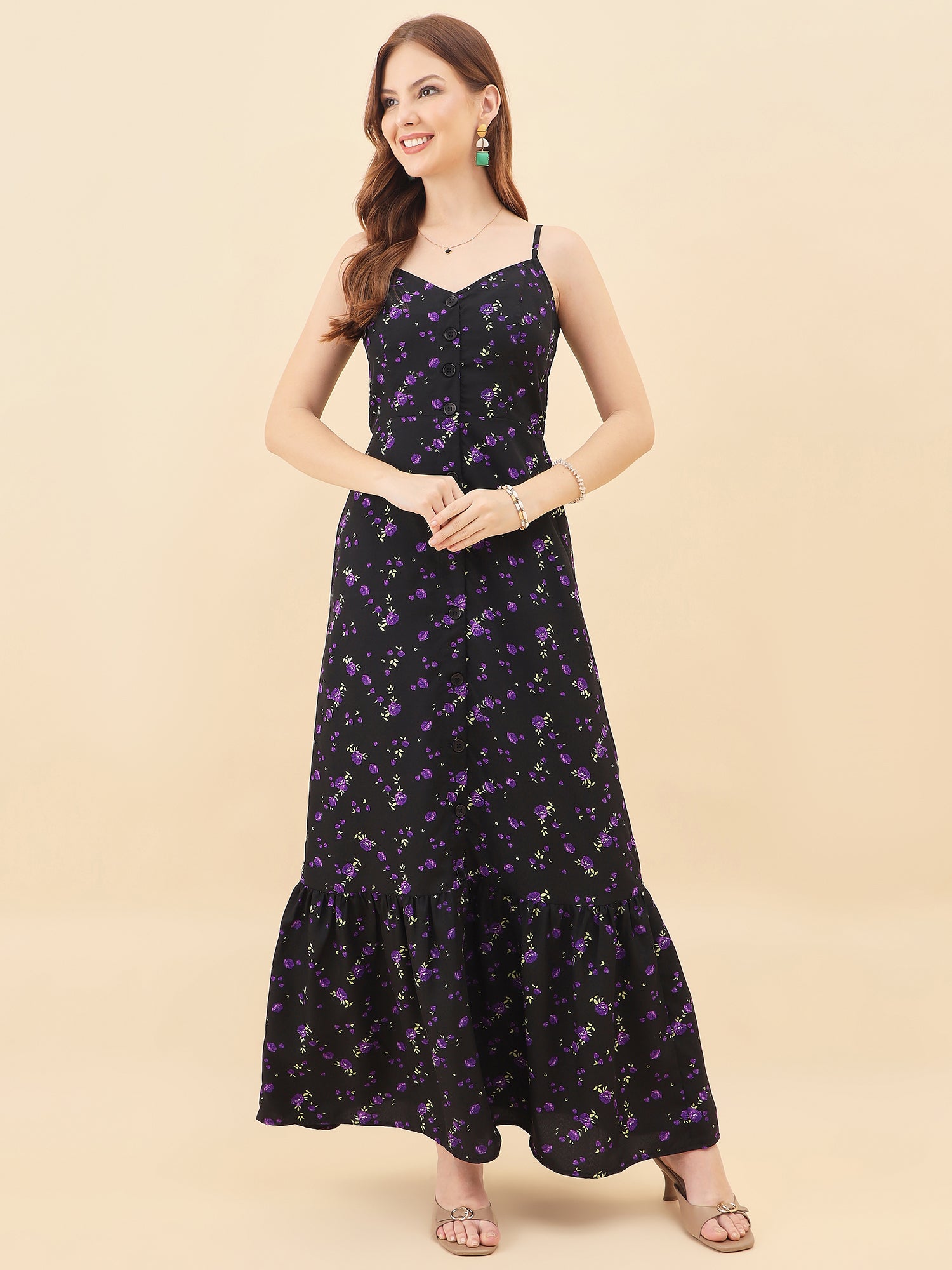 Woman wearing a black floral dress on a beige background