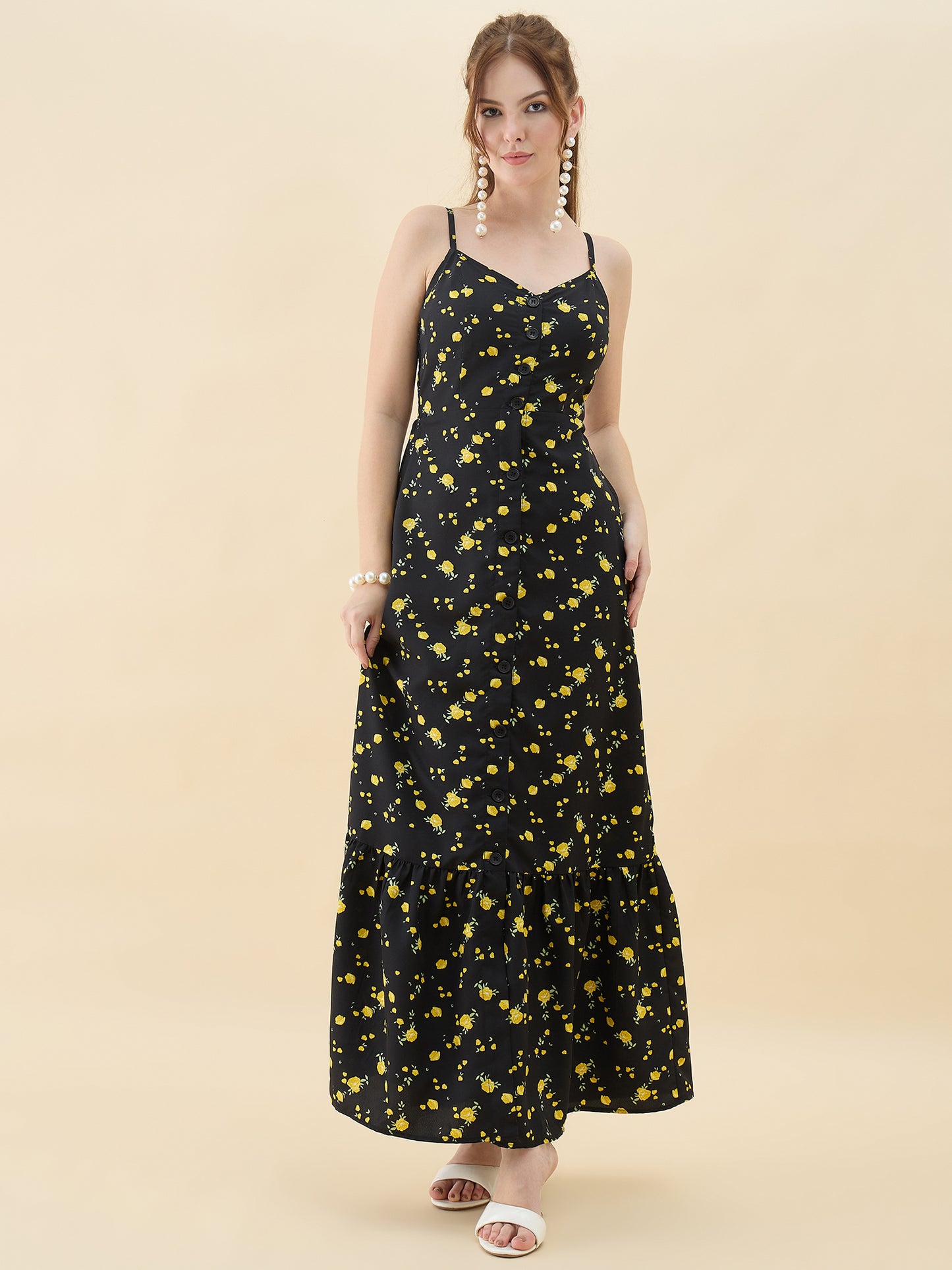 Woman wearing a black floral dress on a beige background