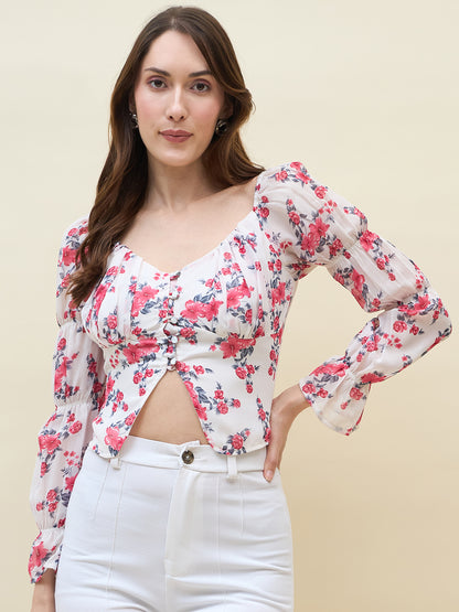 Woman wearing a white & pink floral top with a beige background