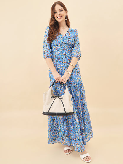 Woman wearing a blue floral dress holding a white handbag on a beige background