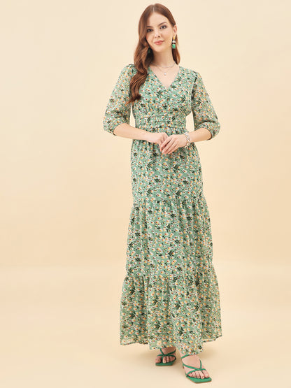 Woman wearing a green floral dress against a beige background